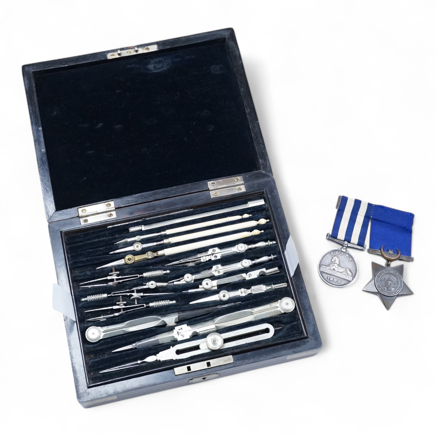 An Egyptian campaign pair awarded to Midshipman C.E.E. Carey RN, comprising the Egypt campaign medal 1882 and the Khedives Star, Khedive's star 1882 unnamed, Associated cased set of chart instruments the lid with plaque